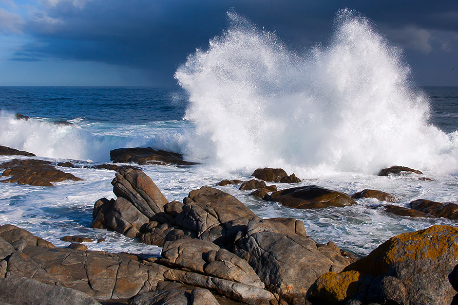 A splash of white spray from storm waves against the incoming blue of a cold front is one of my favourite views of the Atlantic Coast. This photograph was grabbed in the West Coast National Park on the 13th of June, 2010. Contrasting warmth is provided by the rocks in the foreground.               https://hanneliedeklerk.com/views/
