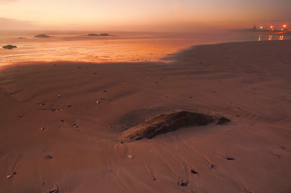 Living in Yzerfontein means I have a blue flag beach within walking distance from my home. During the December holidays it is packed with people, but this shot was taken on 29 May 2012. As winter approaches most of the beachcombers leave and I get to explore the beach by myself. So this is the view that I love: an empty beach at sunset, a receding tide, and just enough light to make the reflections and colour last through the magic of the camera.