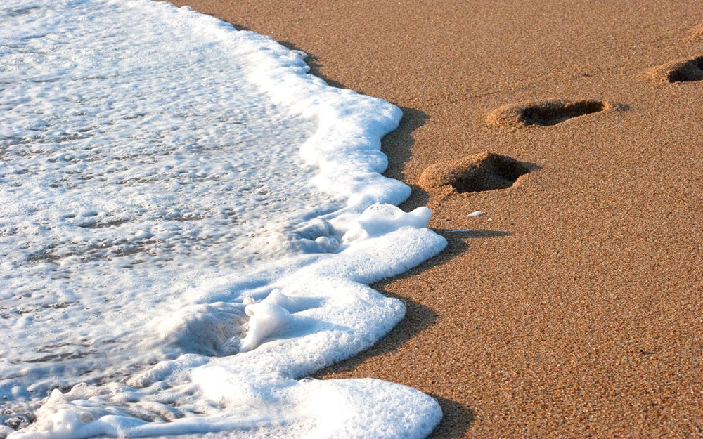 eMdloti: walking into the Indian Ocean - feet being kissed by warm waves